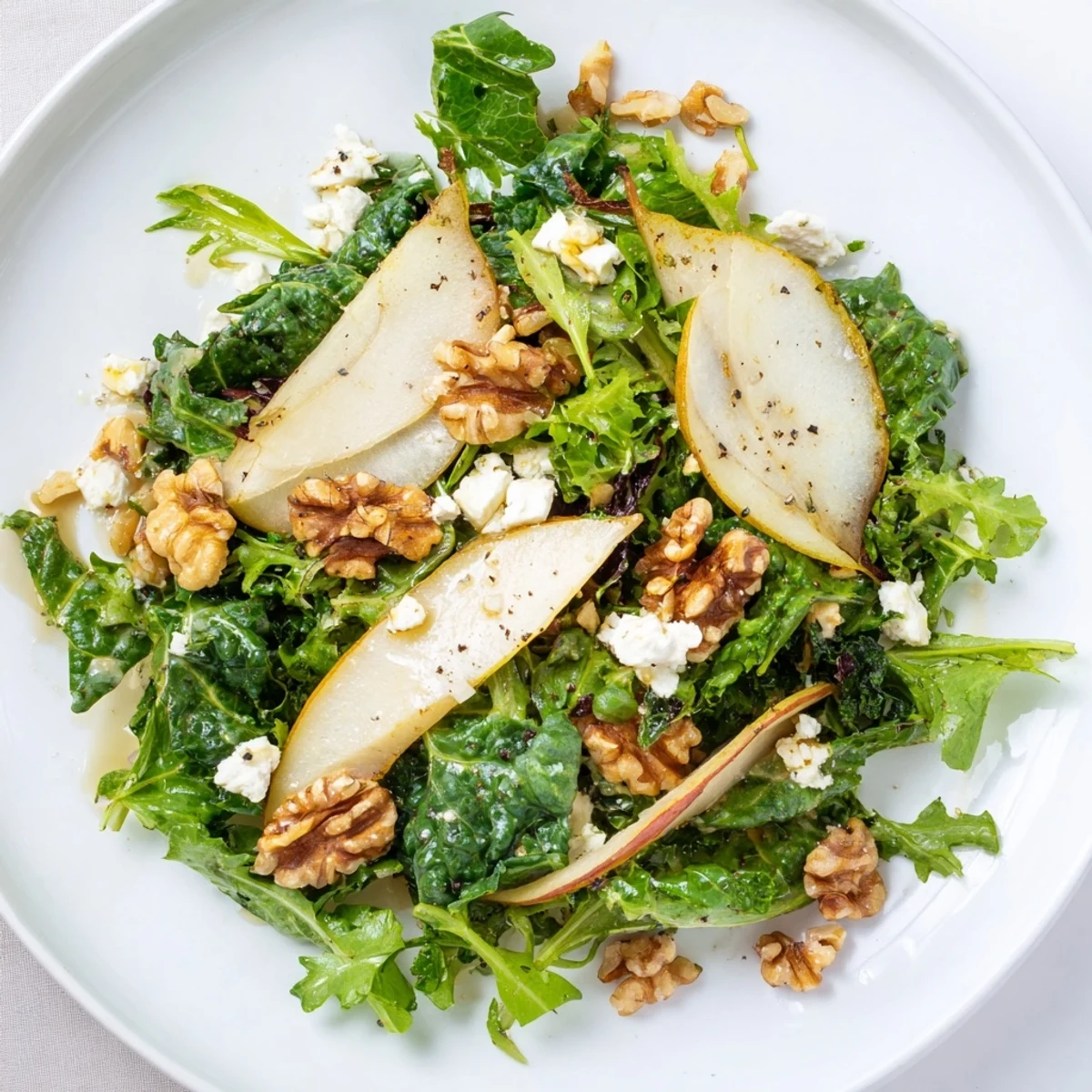 Served in a rustic bowl, the Winter Green Salad with Pear and Walnuts is a refreshing side dish ready in just twenty minutes.