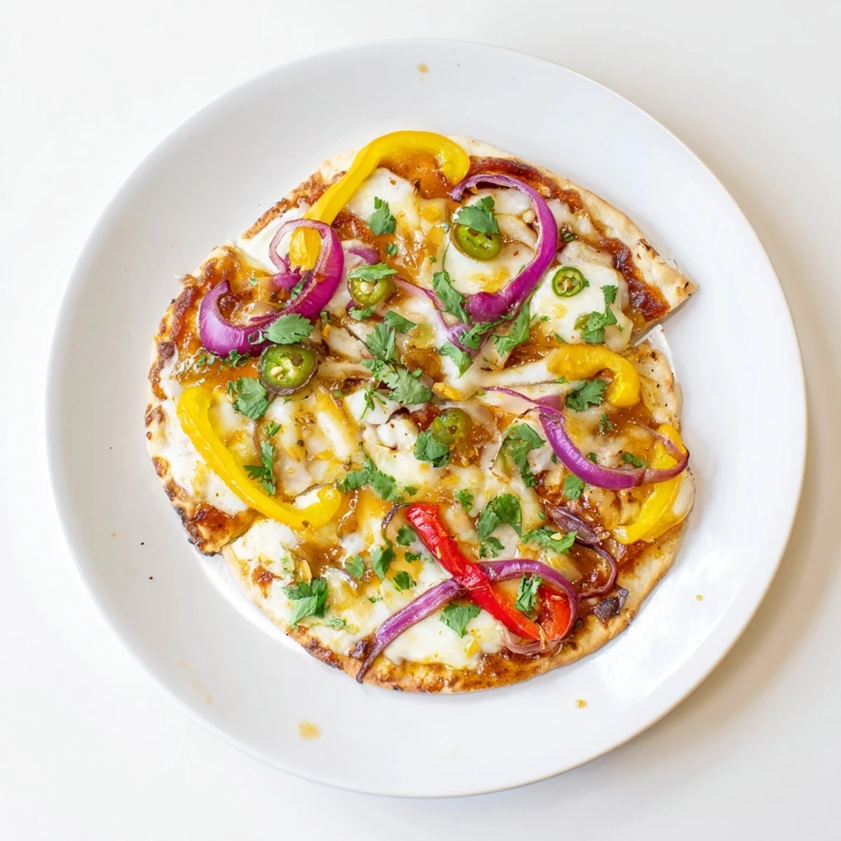 Bubbling cheese and chili flakes top this Sweet Heat Honey Garlic Flatbread Pizza, served on a wooden board.