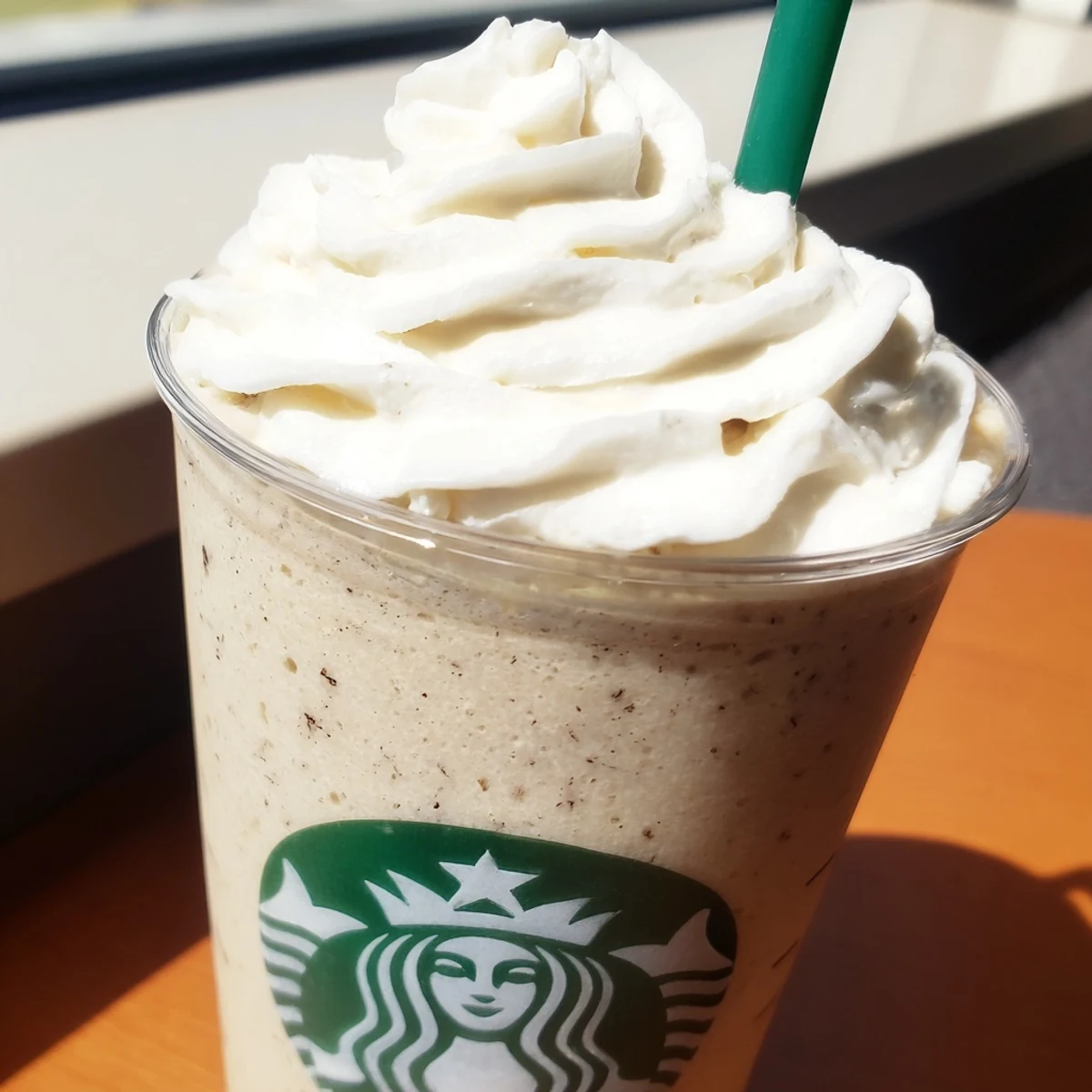 Chilled Starbucks Vanilla Bean Frappuccino in a tall glass, garnished with whipped cream, perfect for a sweet treat.