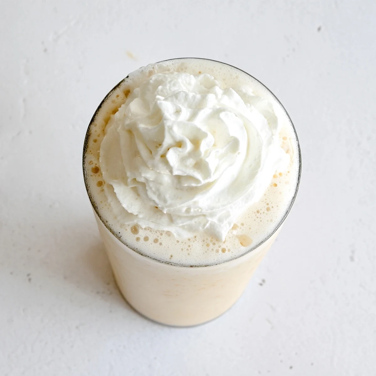 Refreshing Starbucks Vanilla Bean Frappuccino served with a colorful straw in natural light.