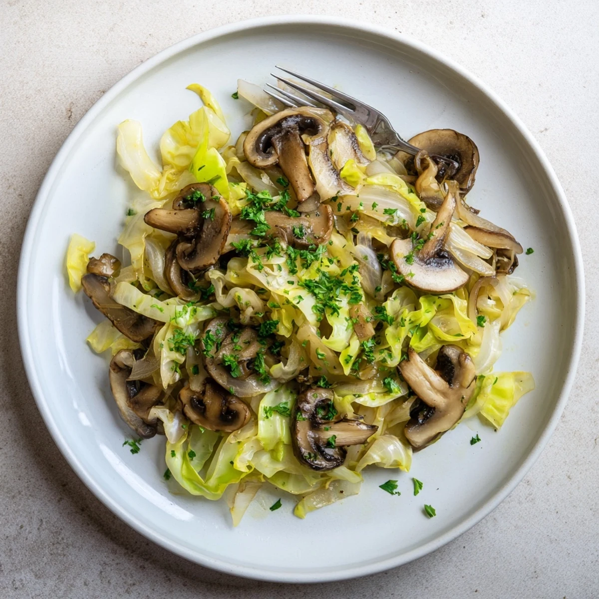 Golden-brown Vegetarian Cabbage Mushroom Sauté sizzling in a skillet, garnished with fresh parsley and served alongside fluffy quinoa.