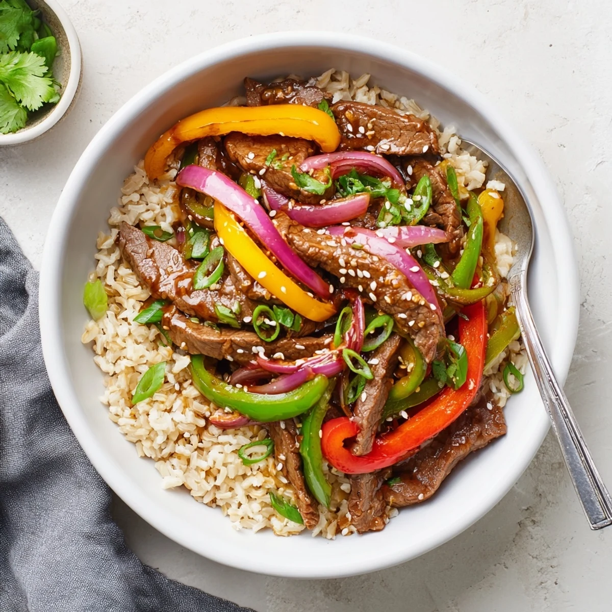 Savory garlic-ginger beef and pepper mixture mounded over steamed brown rice in this Healthy Beef and Pepper Rice Bowl