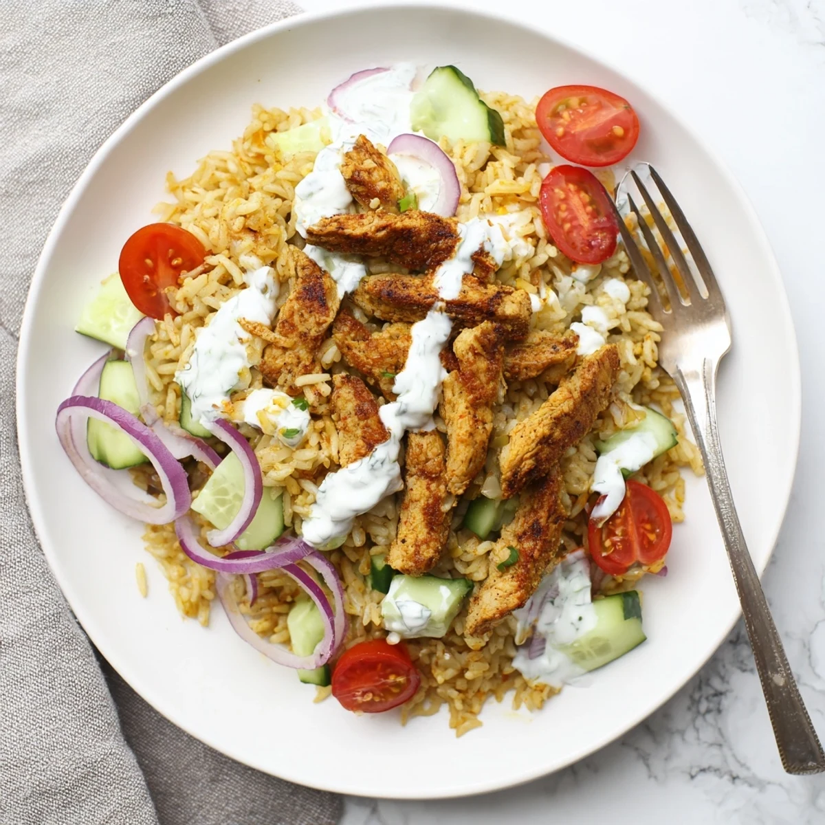 Savory Middle Eastern chicken shawarma crispy rice salad featuring crunchy golden rice and juicy tomatoes in a bowl