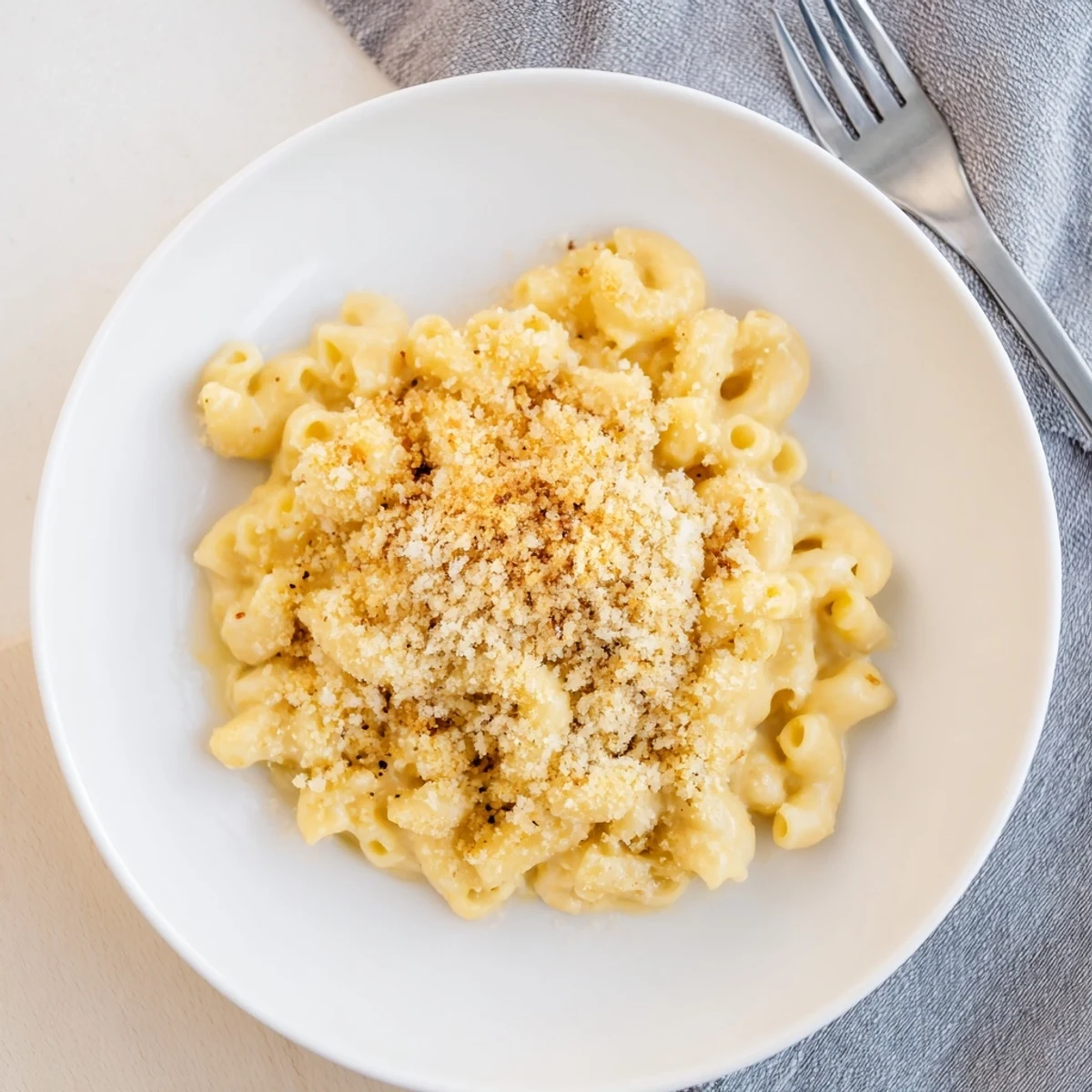 Creamy Boursin mac and cheese with golden breadcrumb topping bubbling in a white baking dish