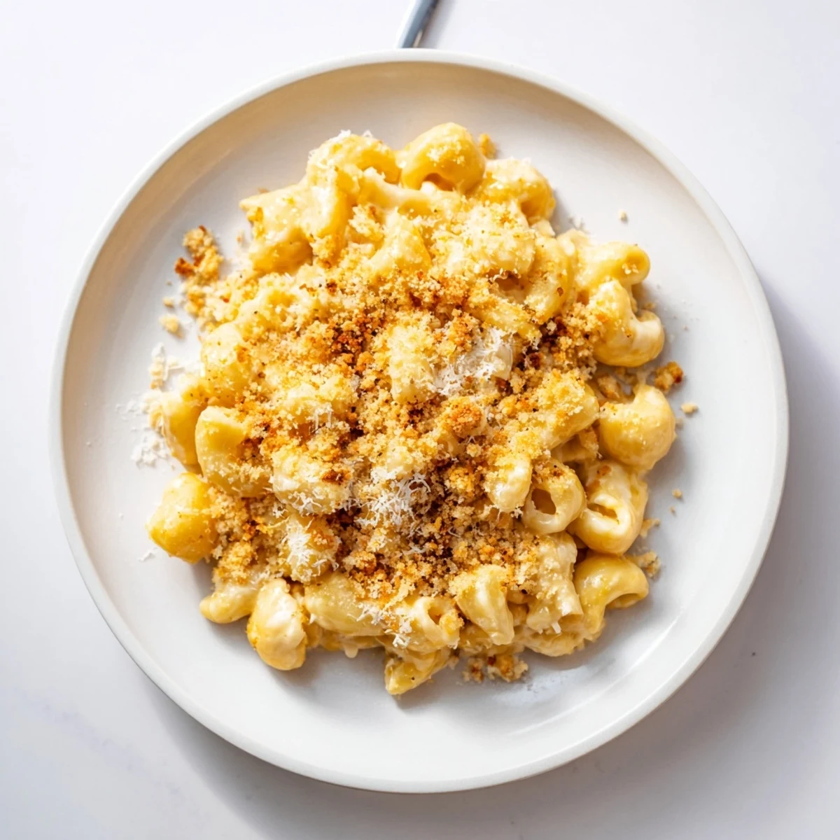 Rich homemade Boursin mac and cheese coated in smooth garlic herb cheese sauce on a plate