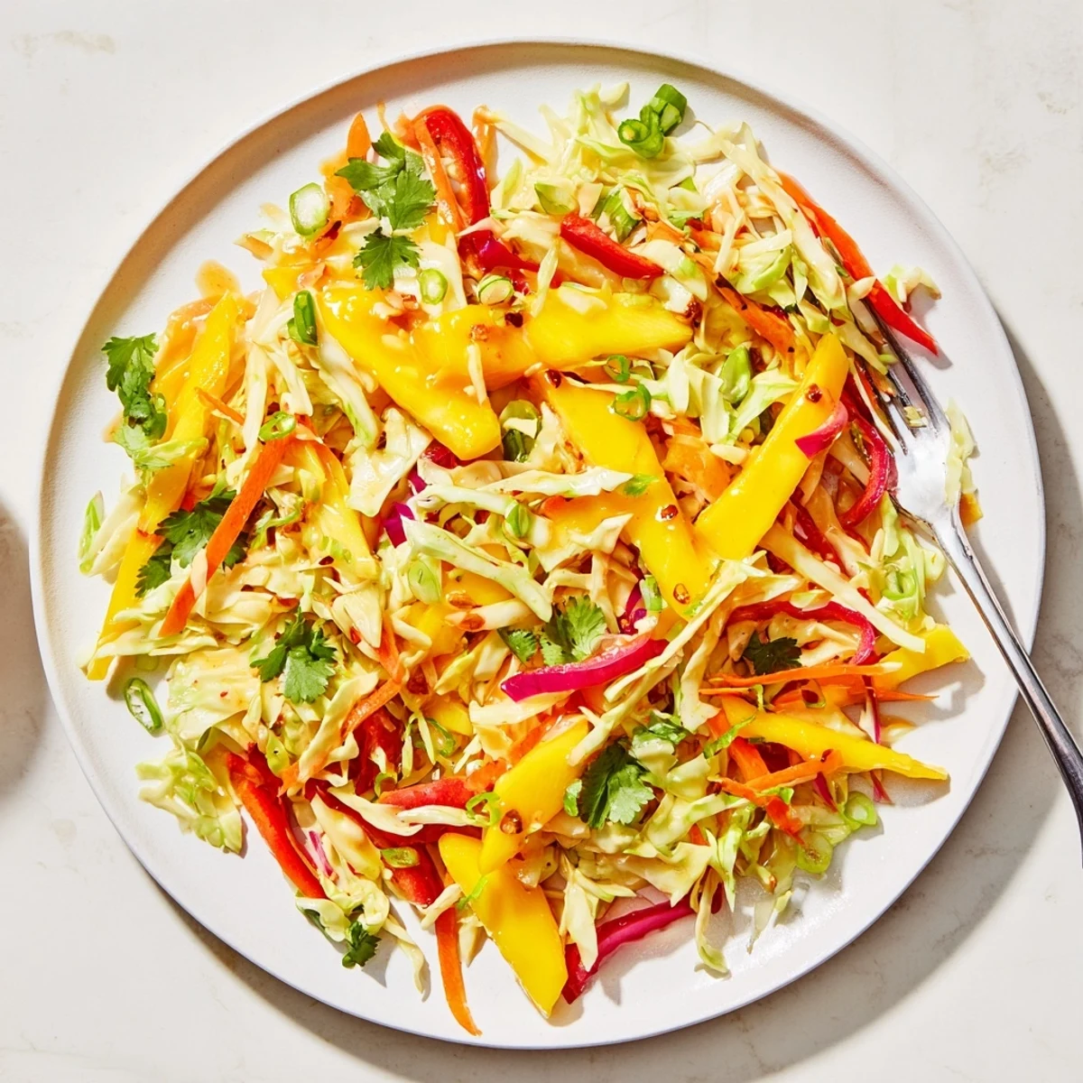 Tangy mango slaw served alongside grilled tacos with crisp julienned vegetables