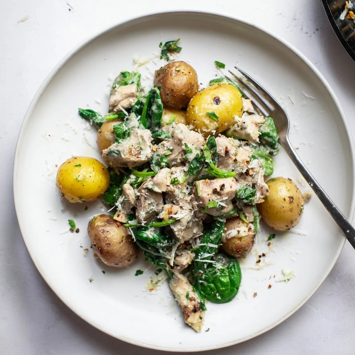 Golden chicken breasts and baby potatoes nestled in rich garlic Parmesan sauce in slow cooker