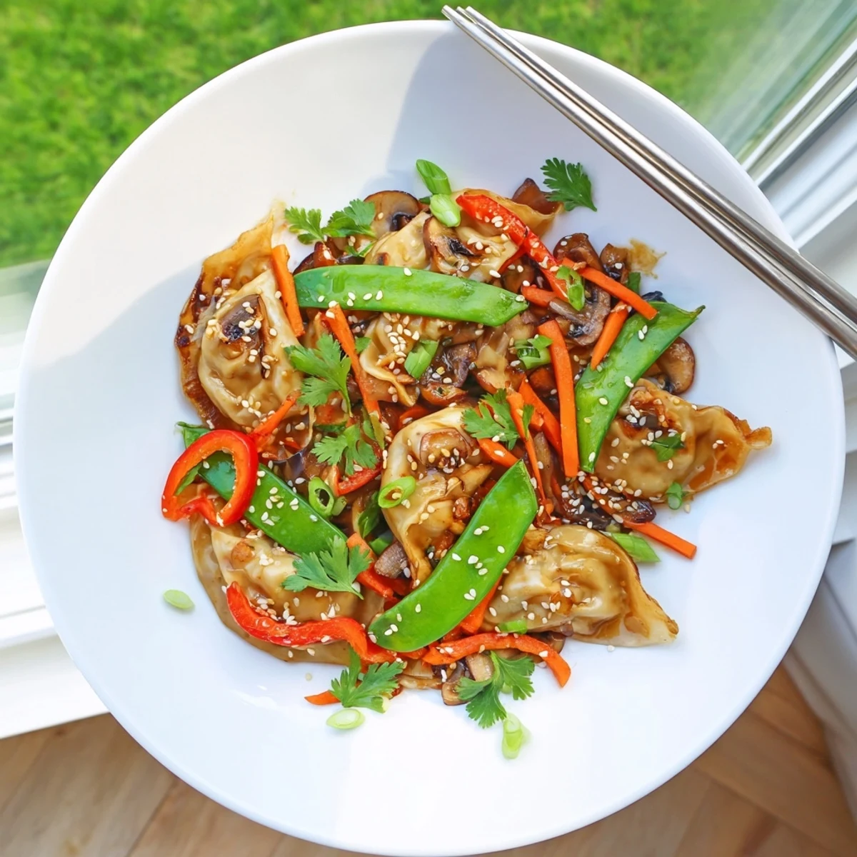 Crispy potstickers wok fried with bell peppers and carrots in glossy soy sauce