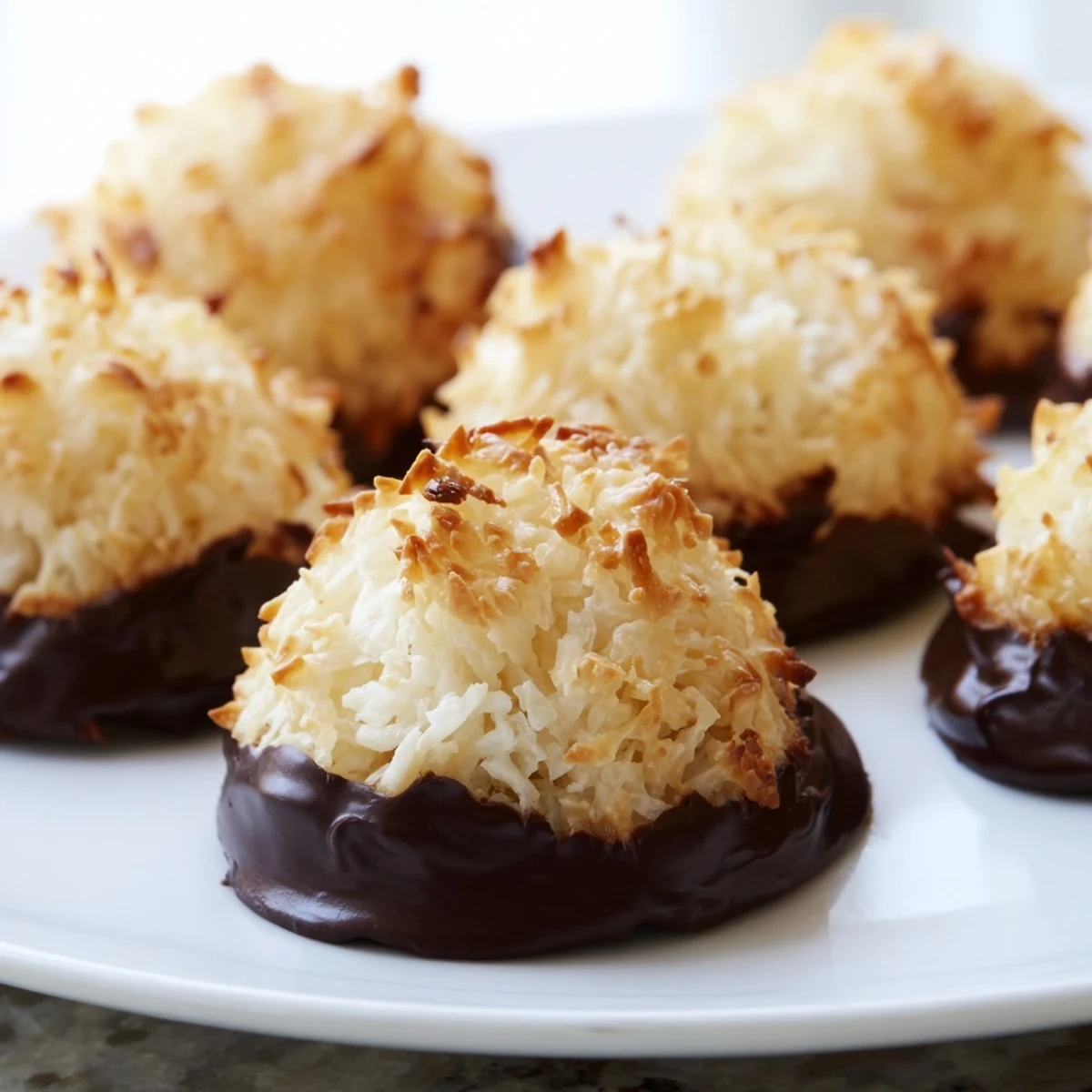 Golden chewy coconut macaroons with crispy edges fresh from the oven on parchment paper
