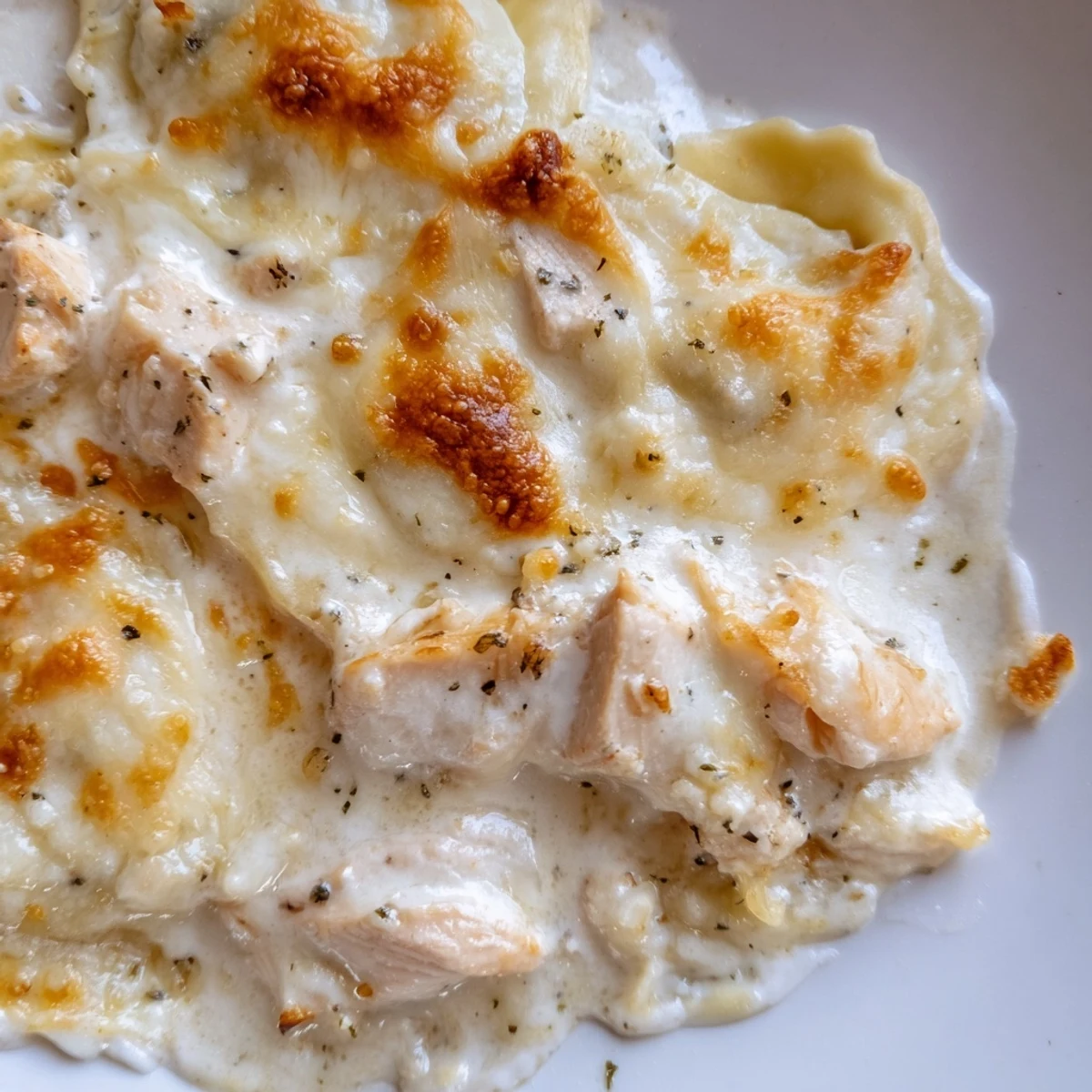 Creamy Chicken Alfredo Baked Ravioli with tender pasta and juicy chicken in rich cheesy sauce