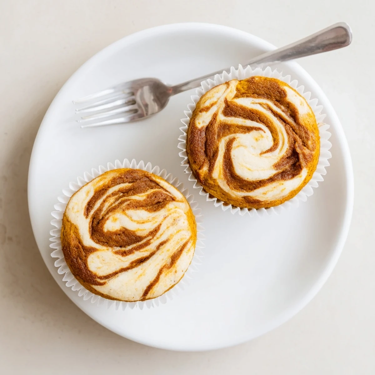 Warm chai pumpkin cheesecake muffins fresh from the oven on a cooling rack