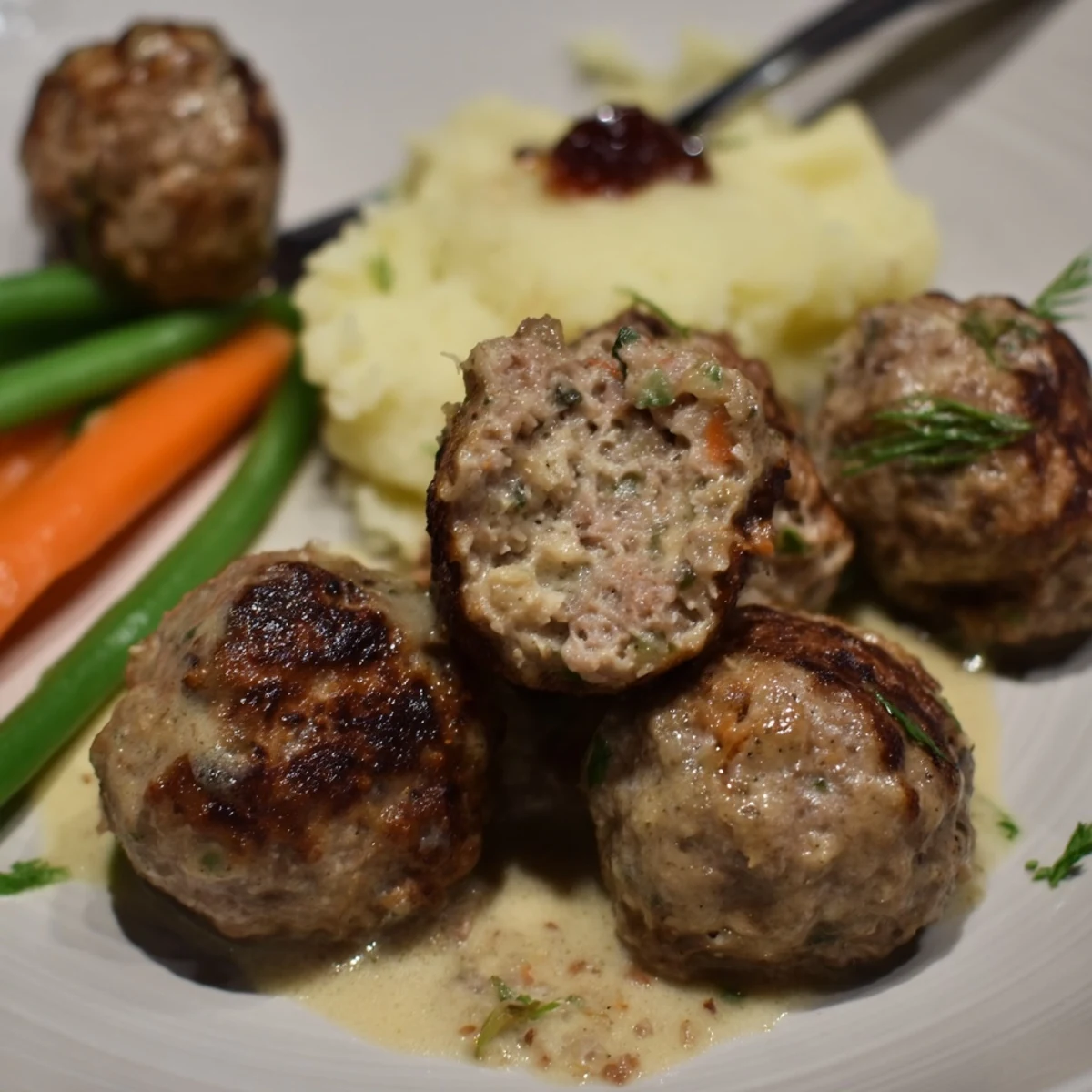 Skillet of Homemade Ikea Meatballs browned and crisp, smelling warm spices and butter