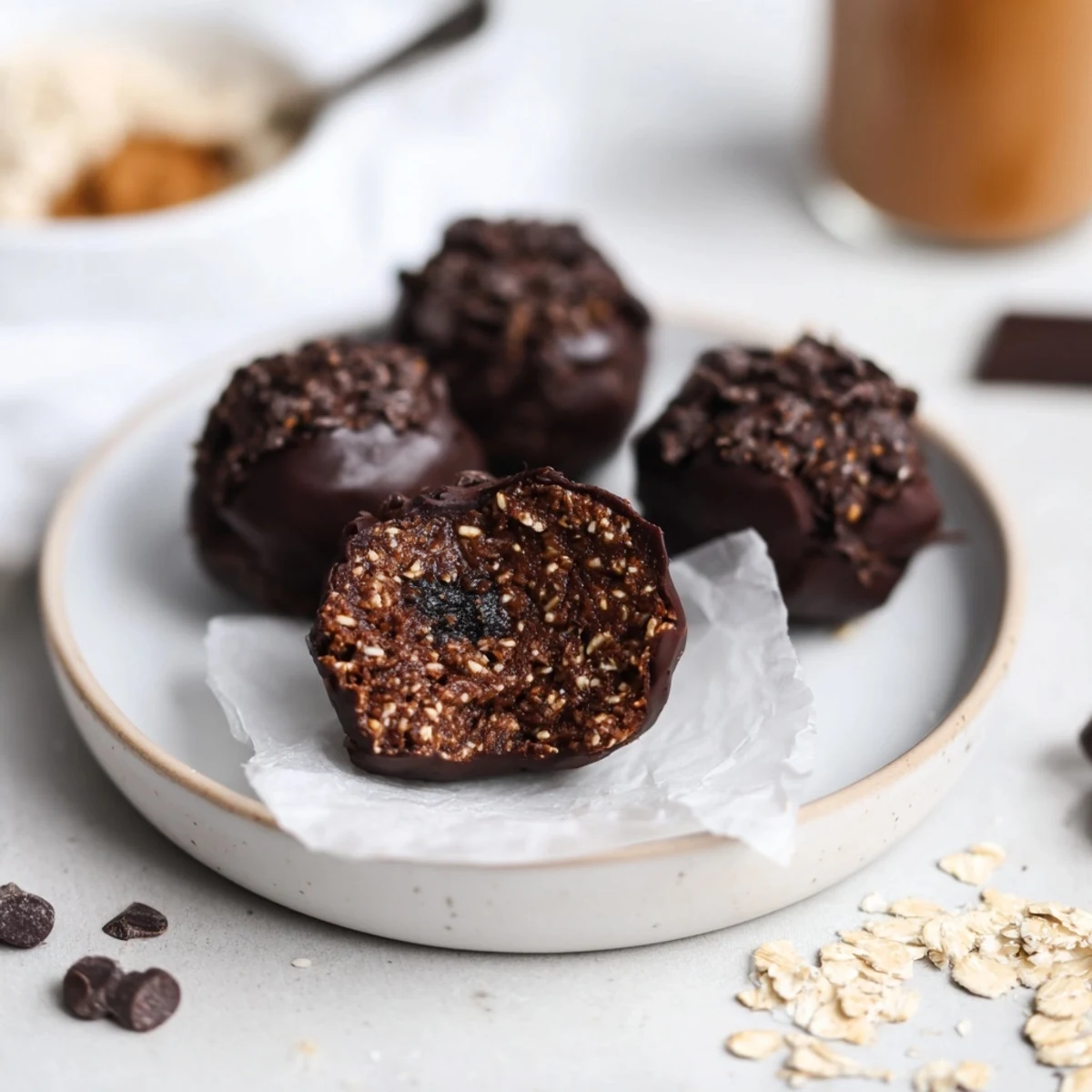 Brownie Protein Bites on parchment, glossy chocolate chips, chewy fudgy texture