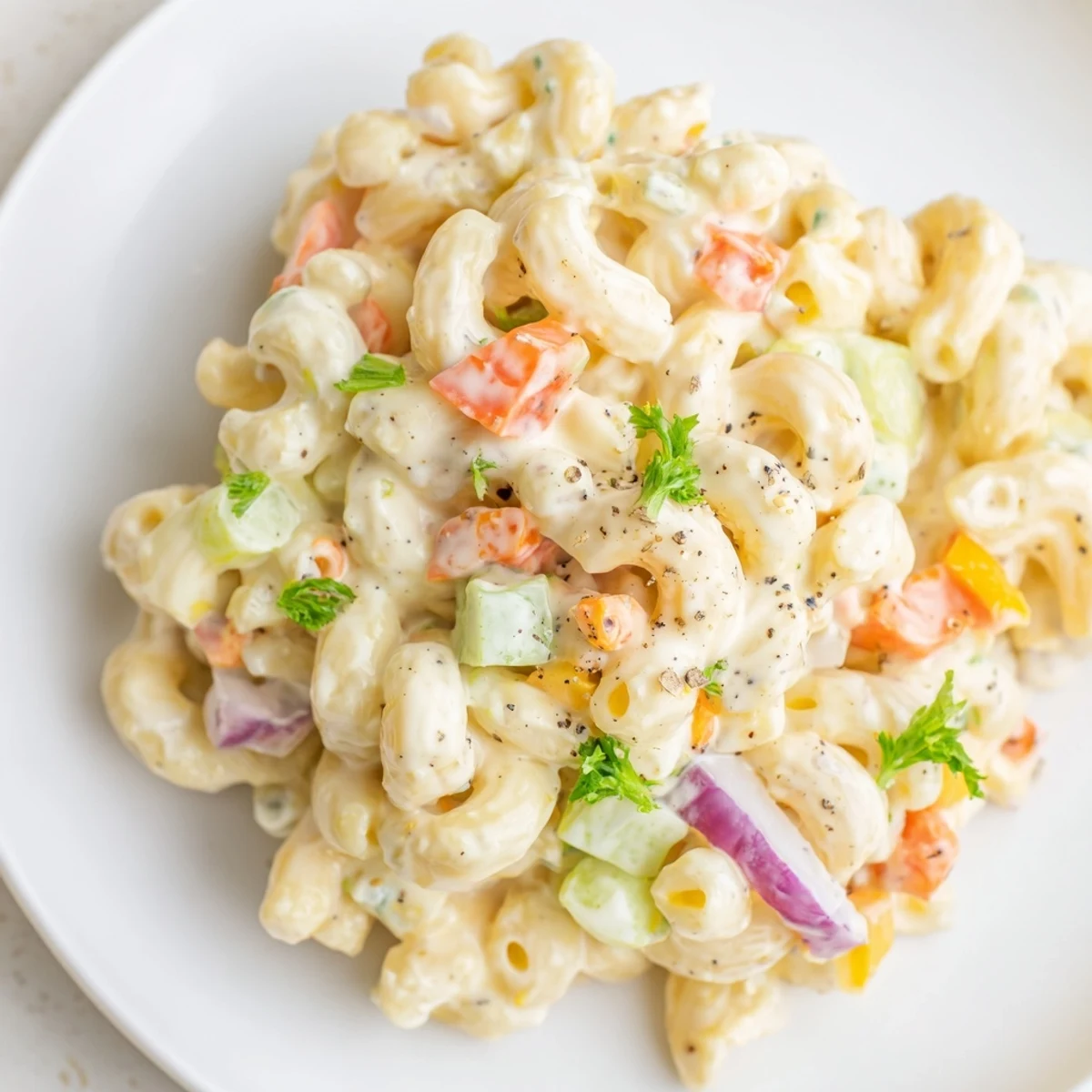Macaroni Salad served on spoon, tender pasta, tangy dressing, parsley