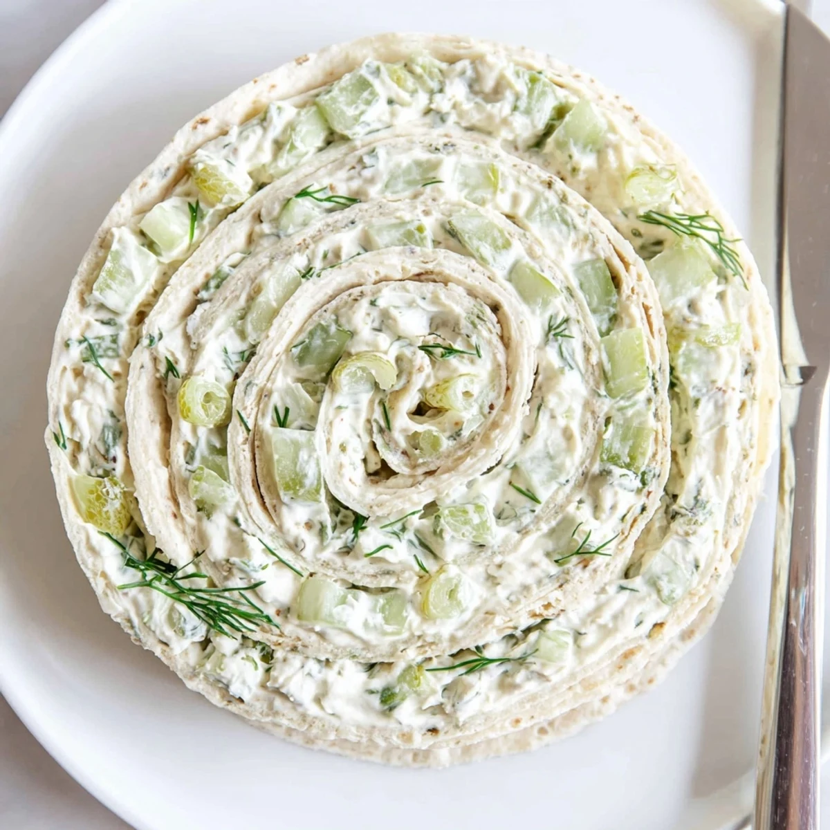Pickle Dip Pinwheels arranged on platter, creamy filling, fresh dill garnish  