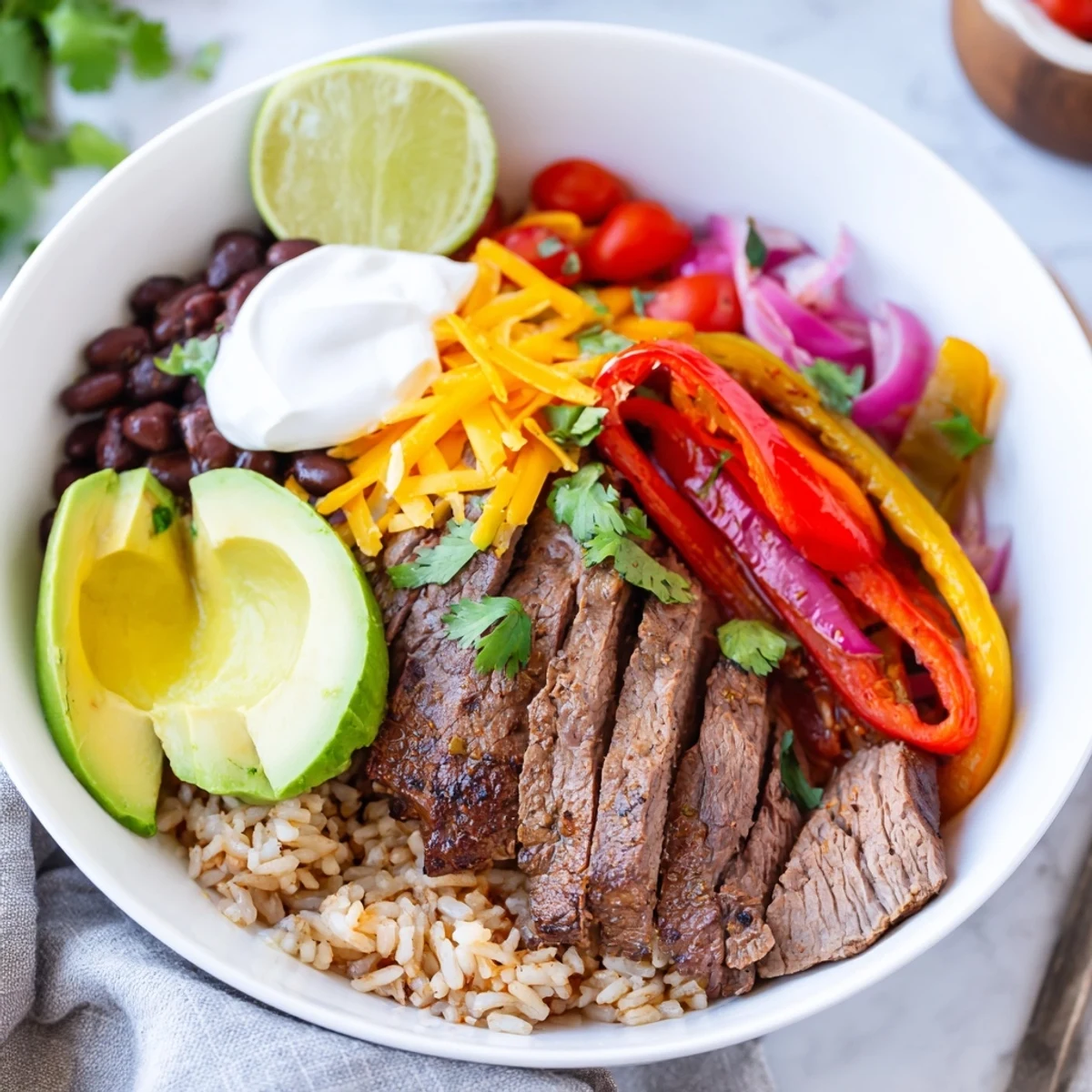 Steak Fajita Power Bowls with sizzling steak, charred peppers, creamy avocado