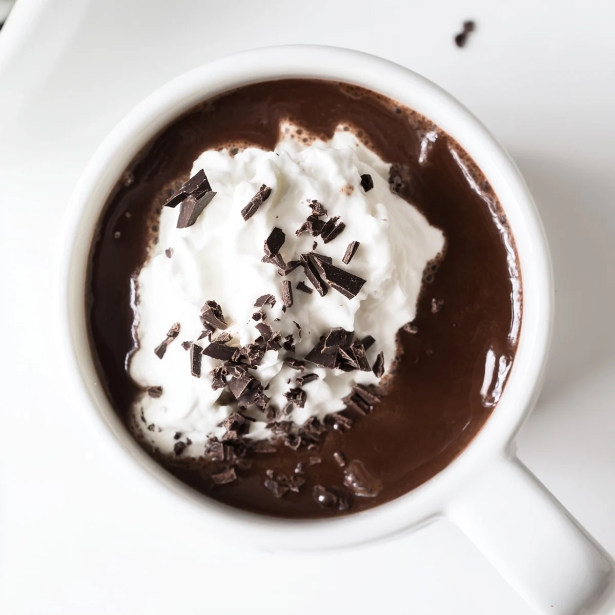 Velvety sugar-free hot chocolate with cocoa swirls and whipped cream garnish in ceramic mugs