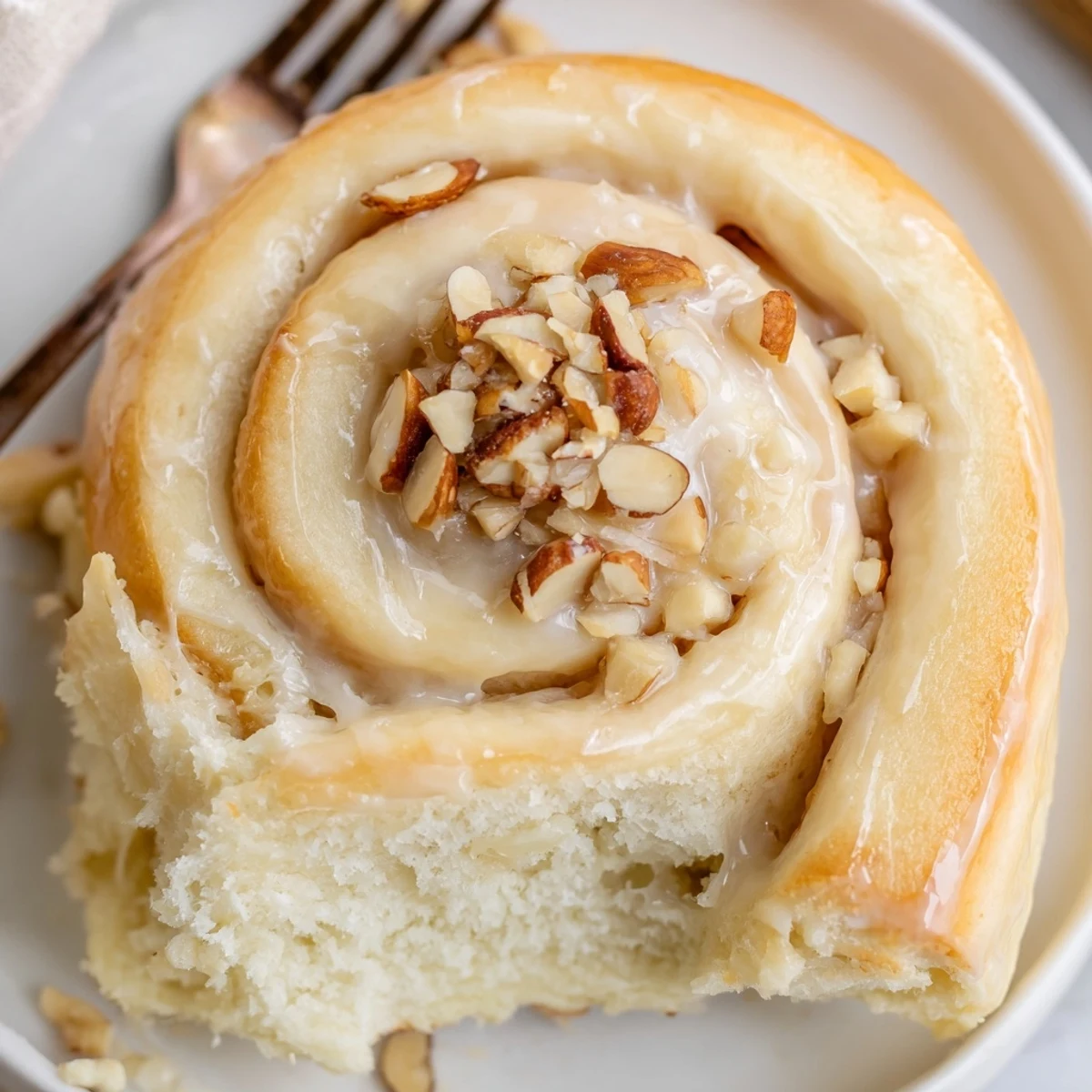 Fresh baked Almond Cream Cheese Rolls with toasted almond garnish, soft pillowy centers