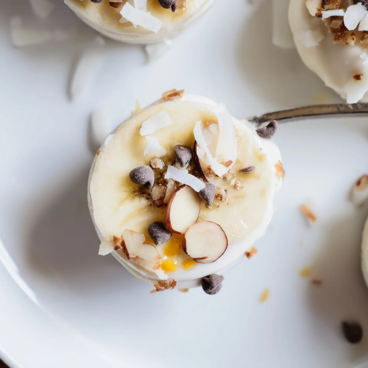 Frozen Banana Yogurt Bites on parchment, creamy, chilled, sprinkled with mini chocolate chips