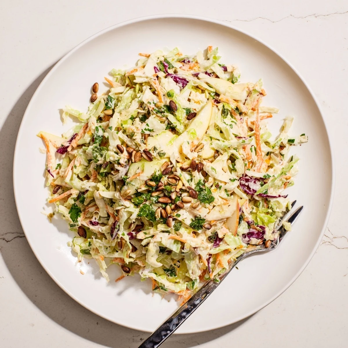 Crisp shredded apple coleslaw with carrots and green onions in tangy homemade dressing