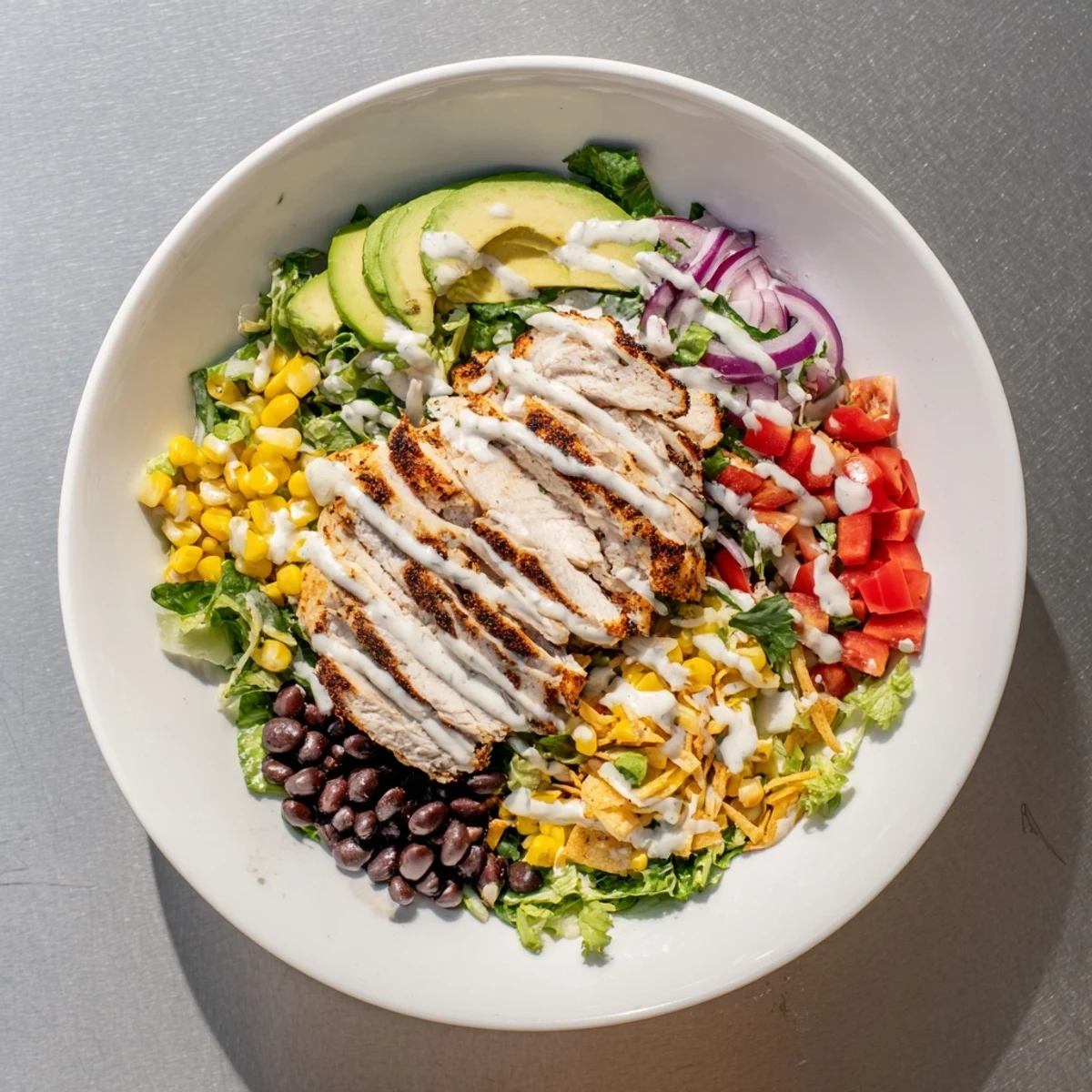 Fresh Southwest chicken salad featuring crisp romaine, black beans, corn, and zesty grilled chicken strips