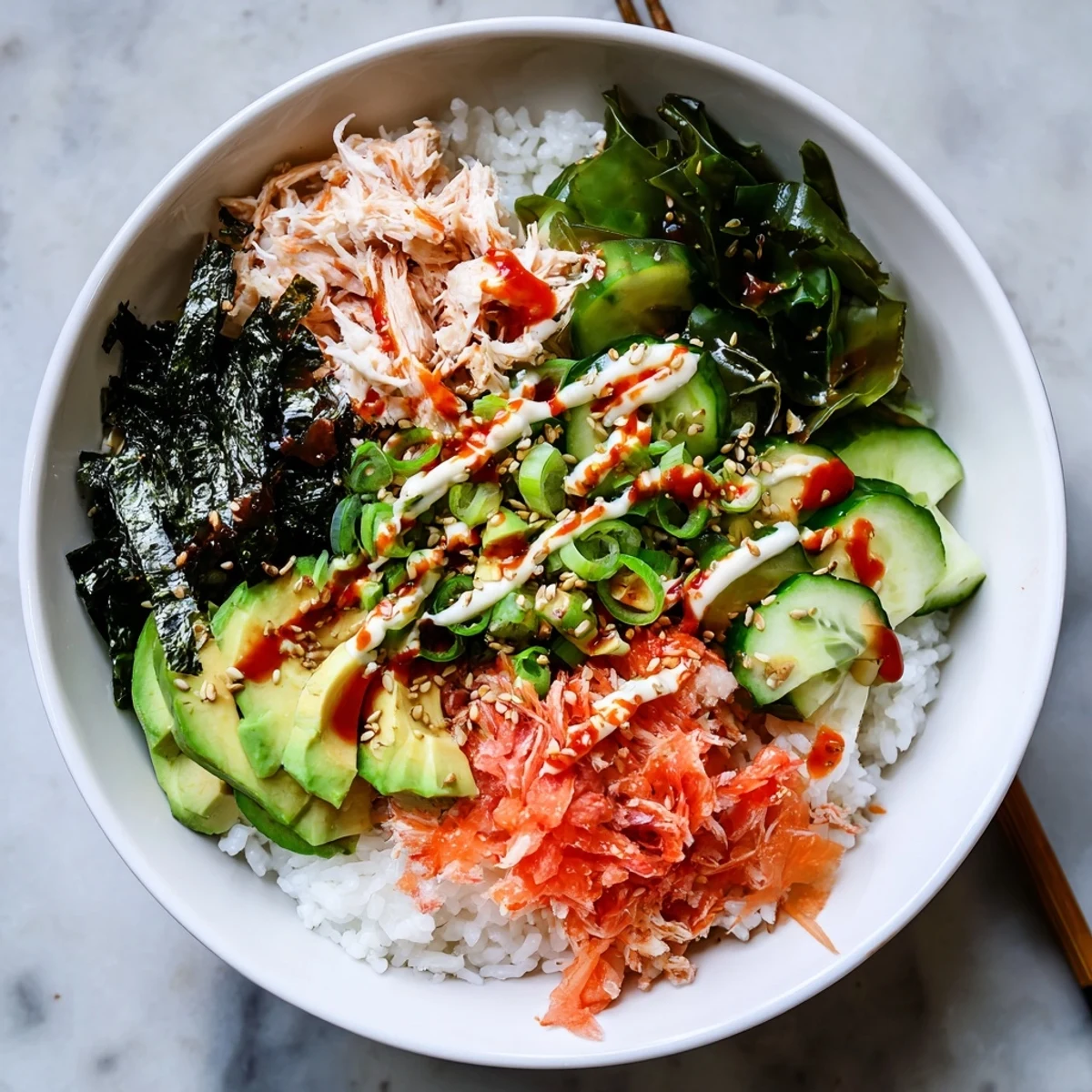 Vibrant California roll sushi bowl arranged with imitation crab, sesame seeds, pickled ginger, and cucumber