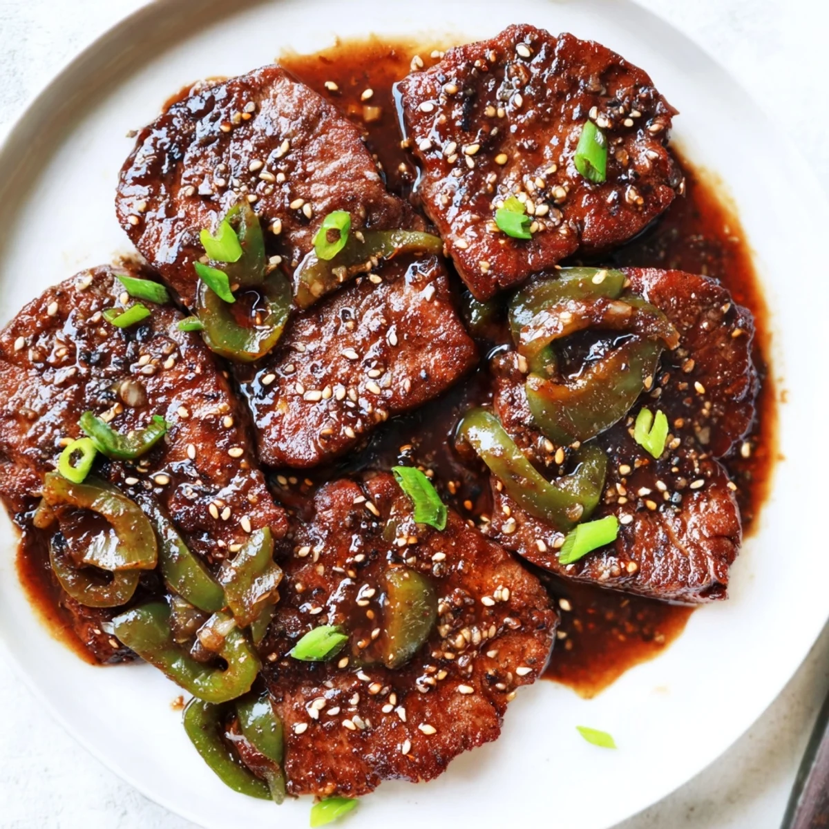 Tender Asian inspired cube steak glazed in rich soy sauce with colorful bell peppers